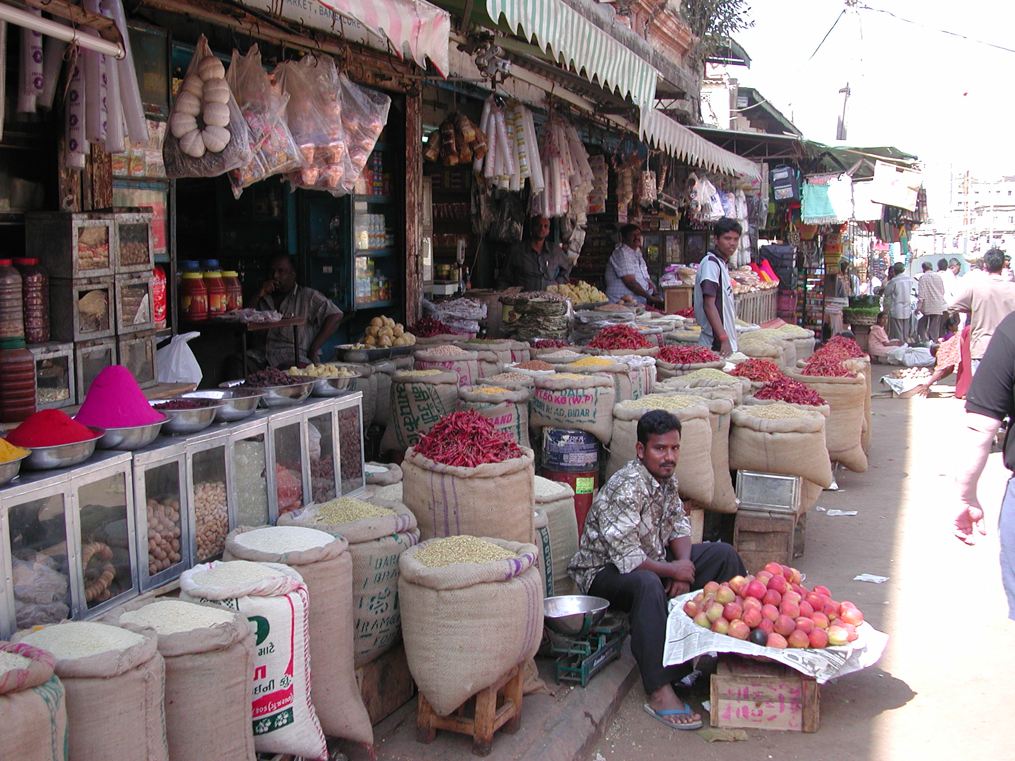 a man sits in front of a market