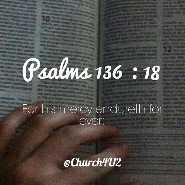 a person is reading the bible with their hands on it