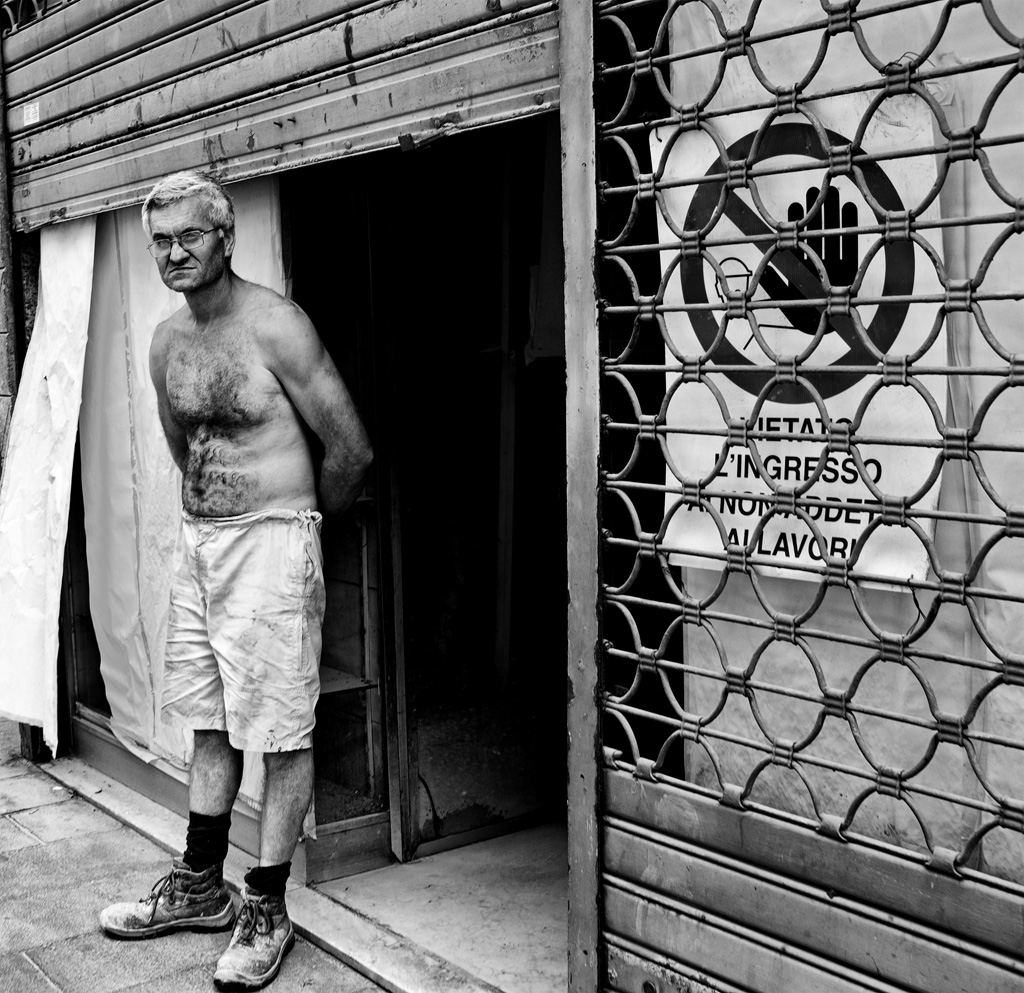 a man with short shorts stands by the door