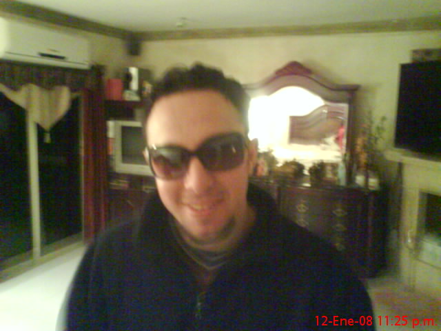 a man wearing sunglasses while looking up at the camera
