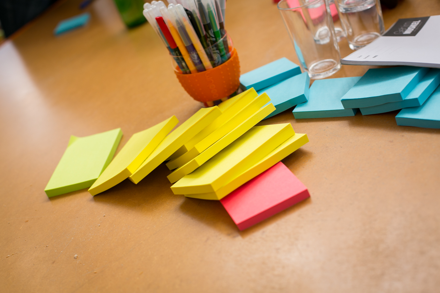 several yellow, blue and pink pieces of paper on a table