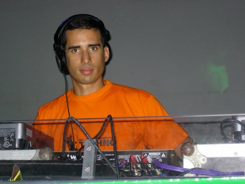 a man with headphones on and an orange t shirt