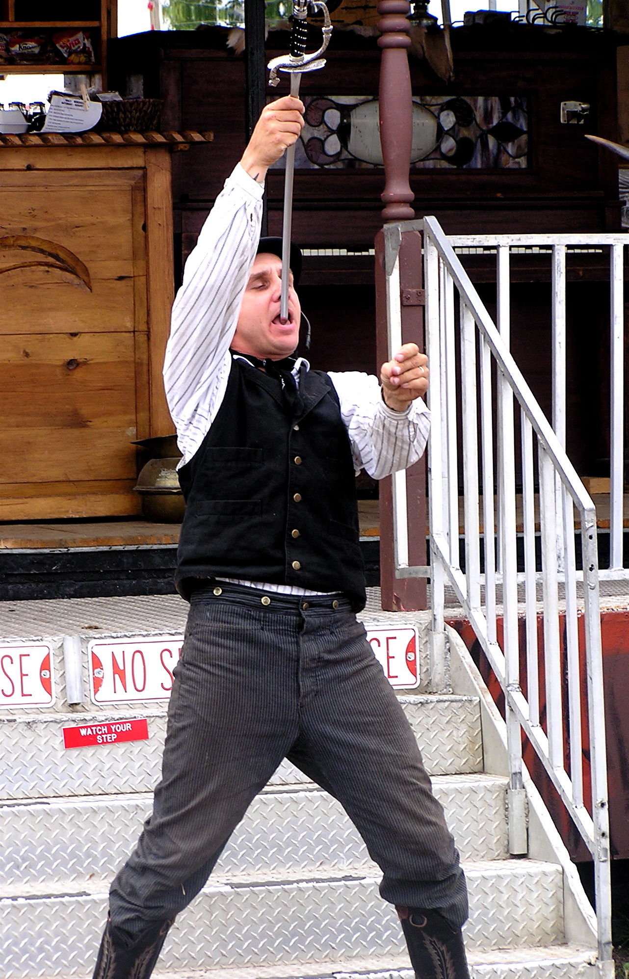 a man with a knife on the steps in front of some stairs