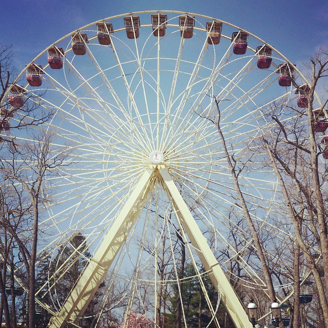 a ferris wheel with red apples attached to it