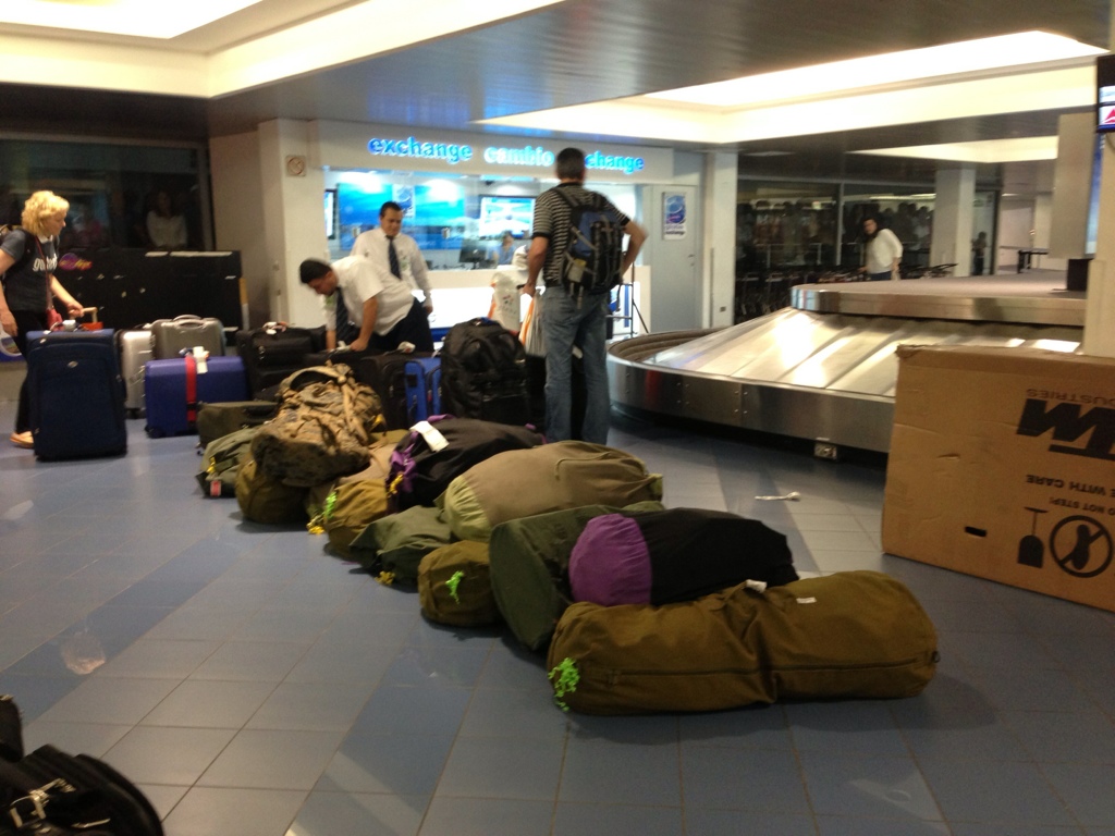 a bunch of bags are waiting for their travelers