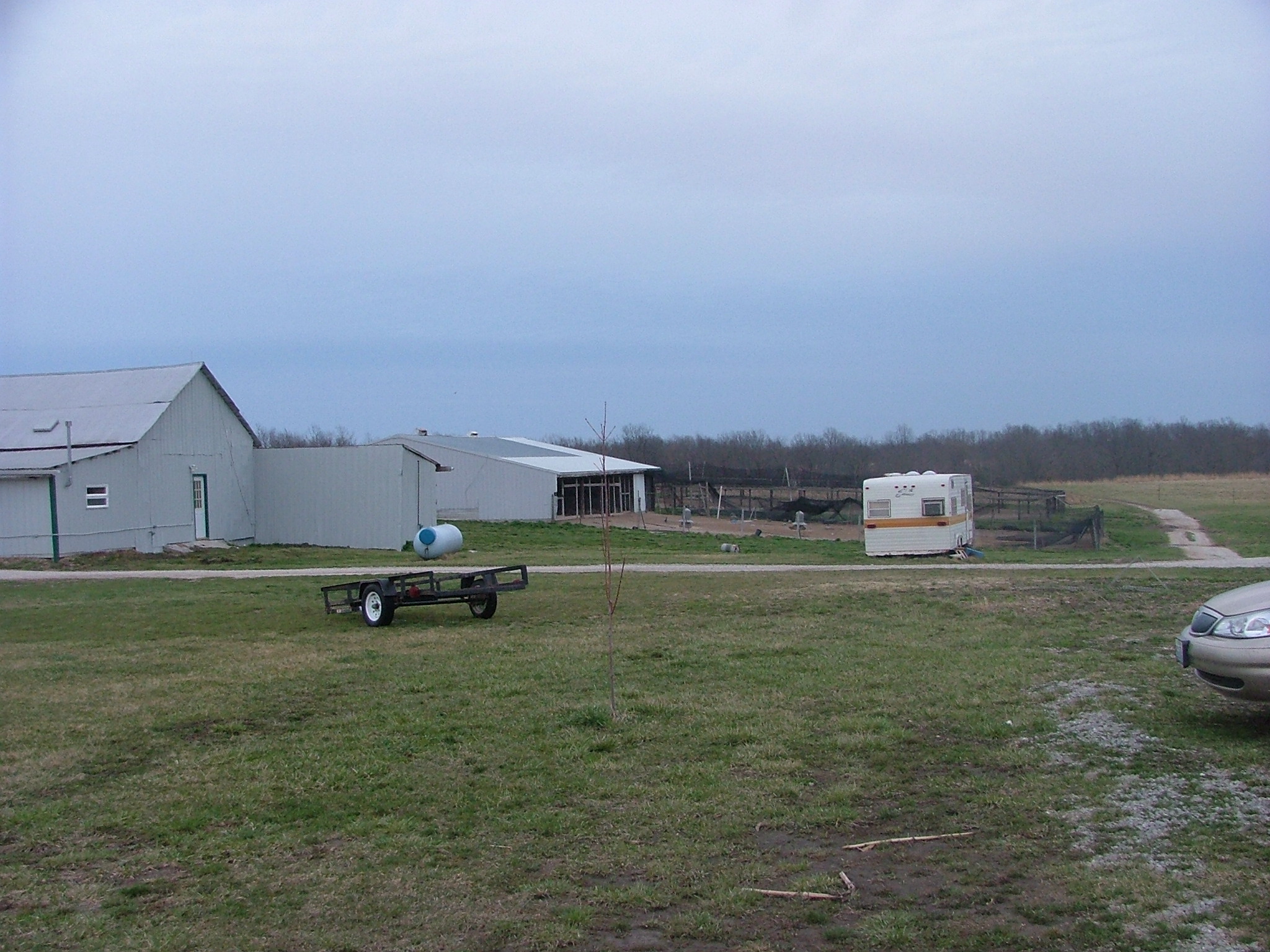 an rv, trailer and trailer parked at the end of a driveway