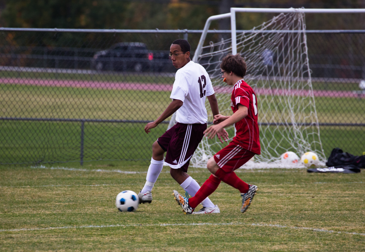 there are two men playing soccer on a field