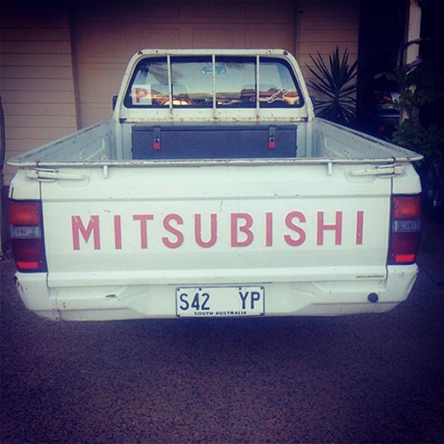an old pick up truck that has the words mtsubshi in it