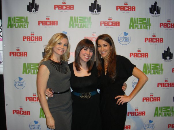 three women pose for a po at an event
