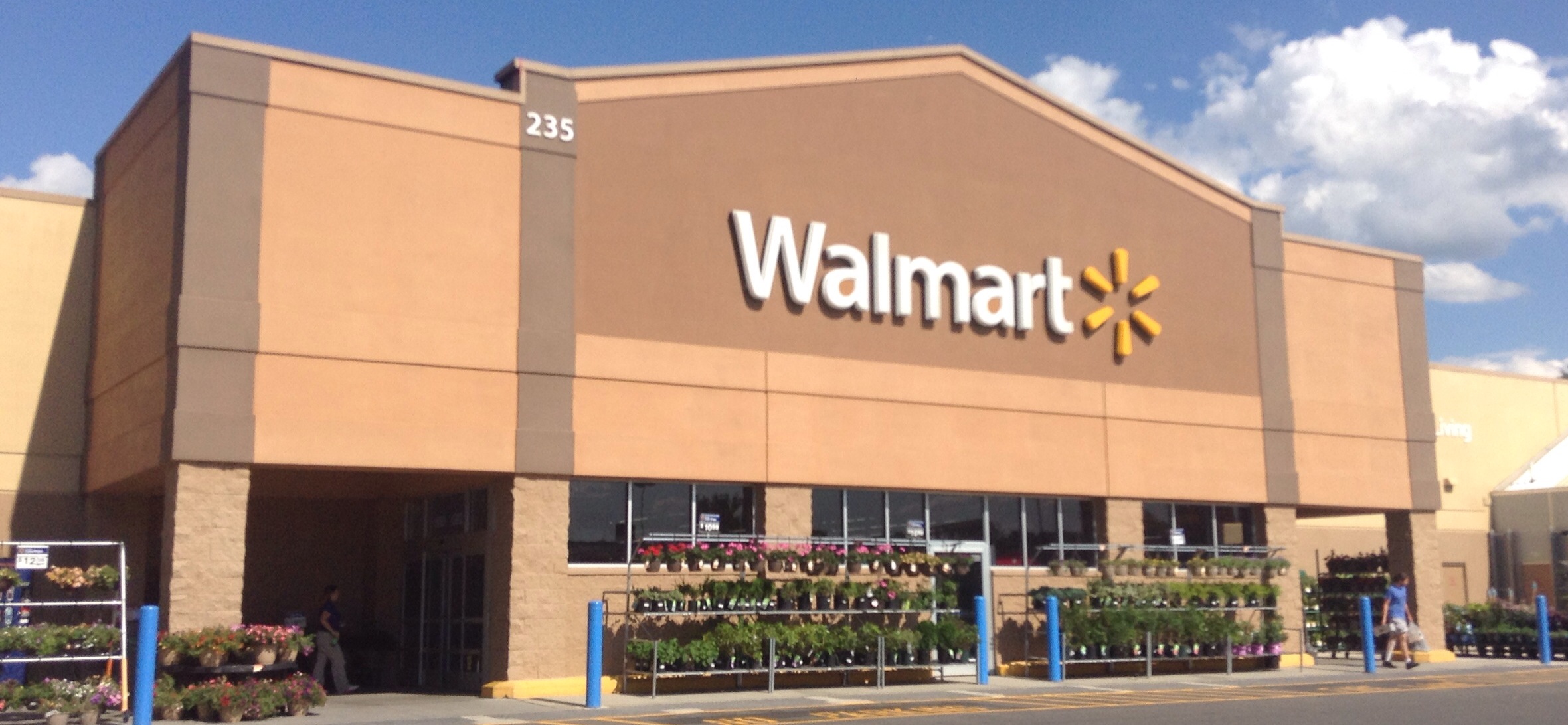 a store is shown with multiple plant boxes and a large sign