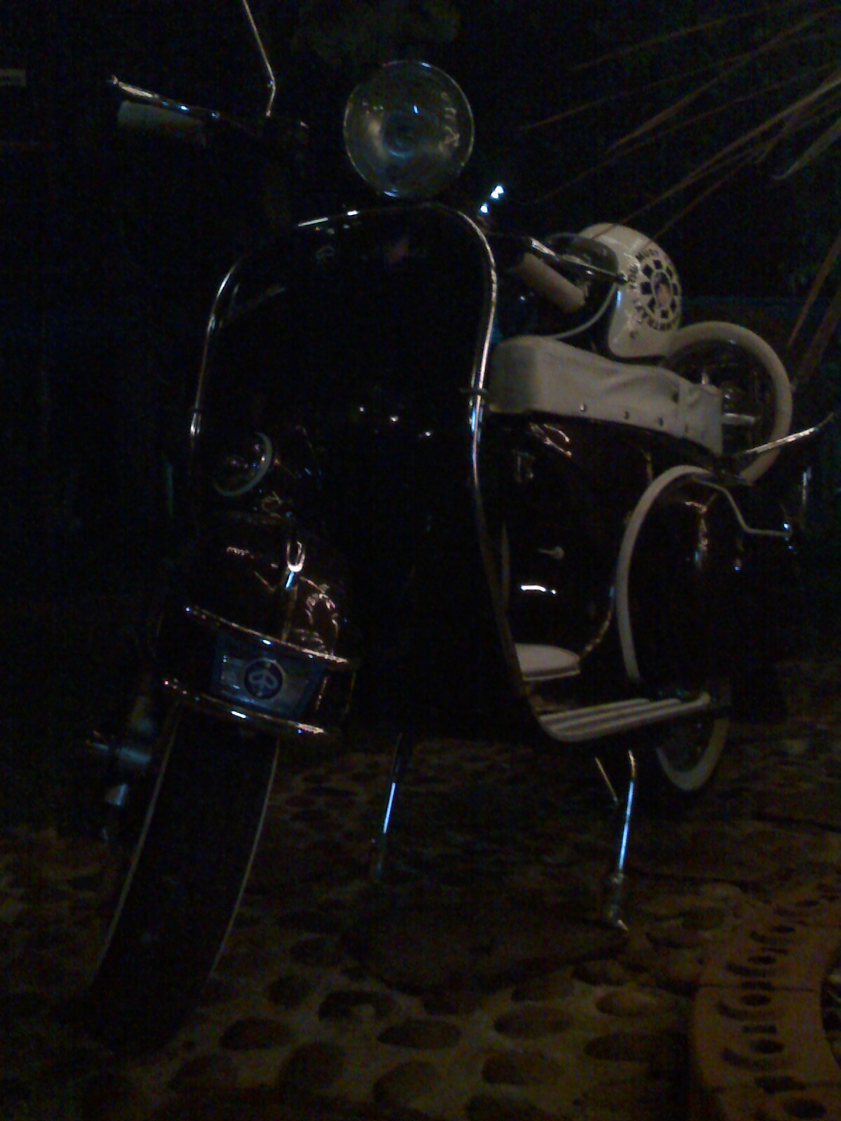 an antique motorcycle is parked in a dark room