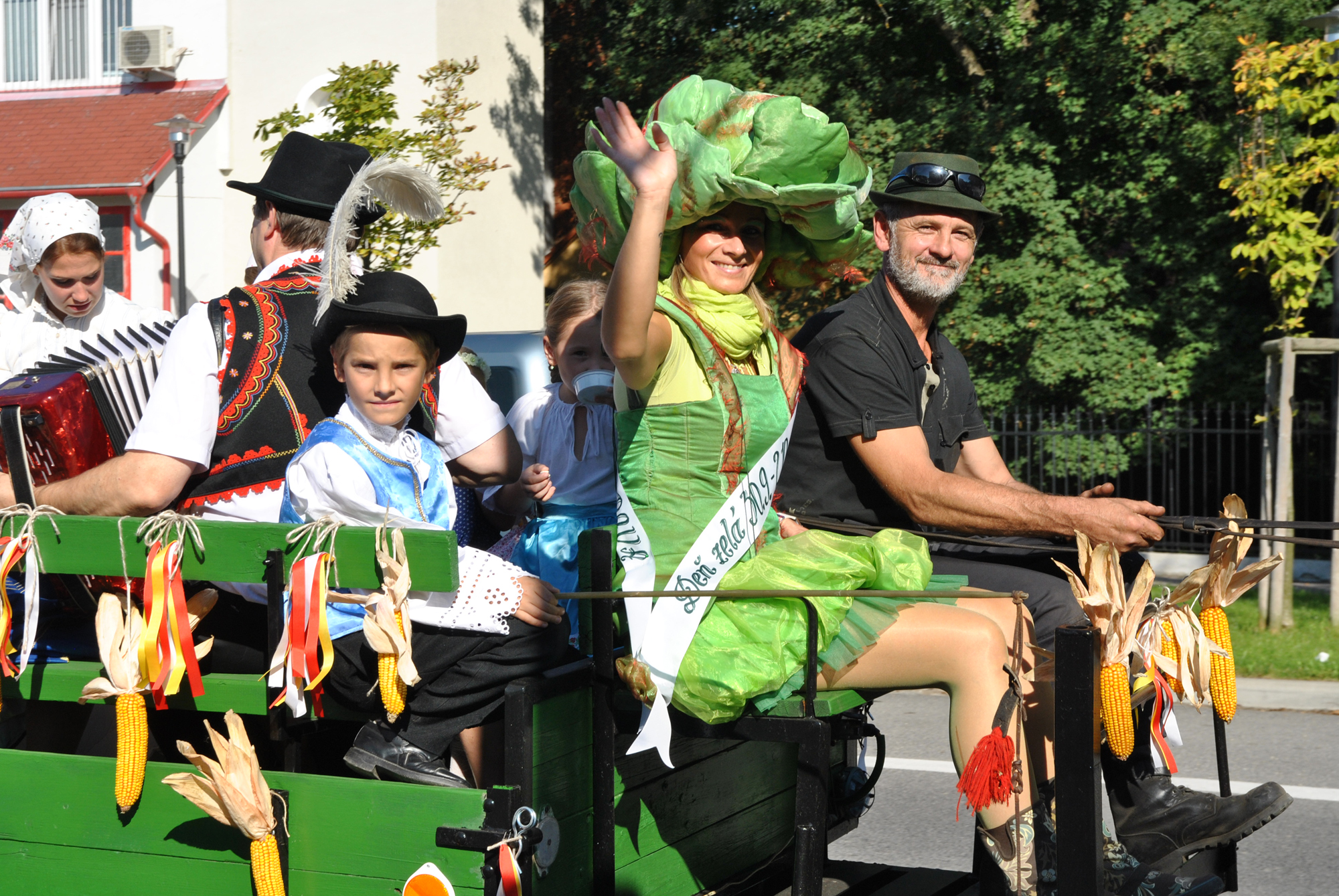 a small wagon with people and dressed up men