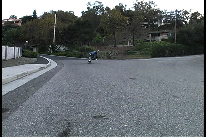 a person riding a skate board on a road
