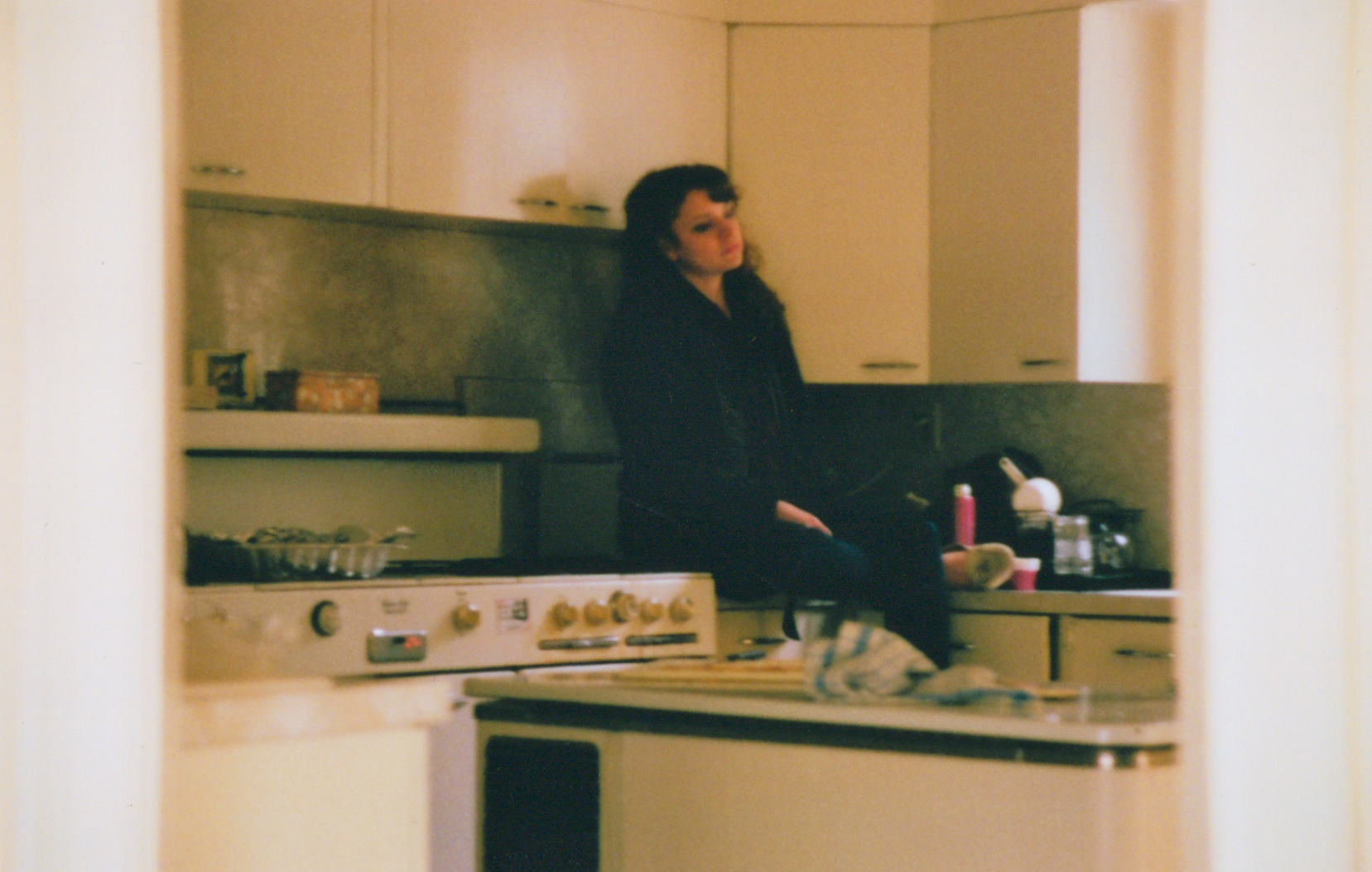 a woman preparing food in the middle of a kitchen