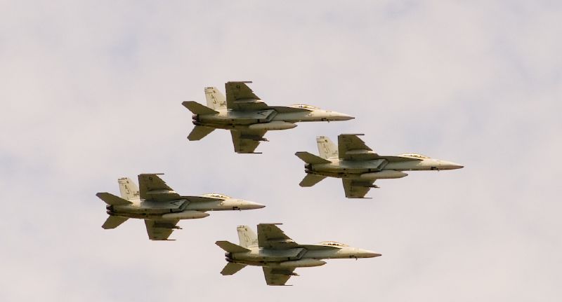 four jets fly in formation in the sky