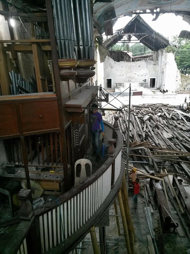 a pipe and wooden beams inside of a structure