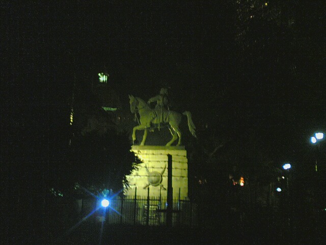 a night scene with the statue of the equestrian on top