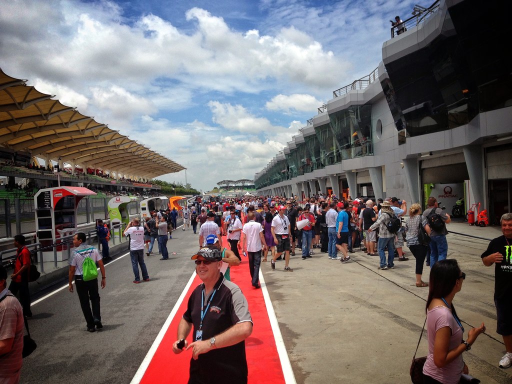 a crowd of people walking next to the track