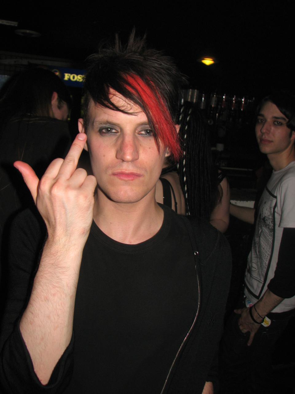 a young person who has red and black hair on their fingers