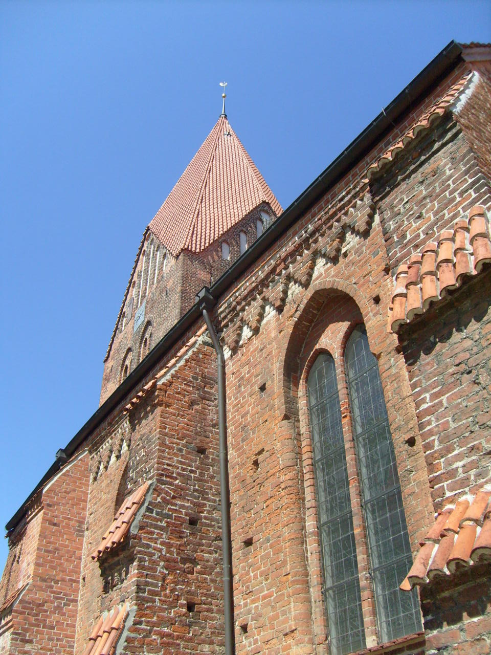 a brick building with windows and a tower