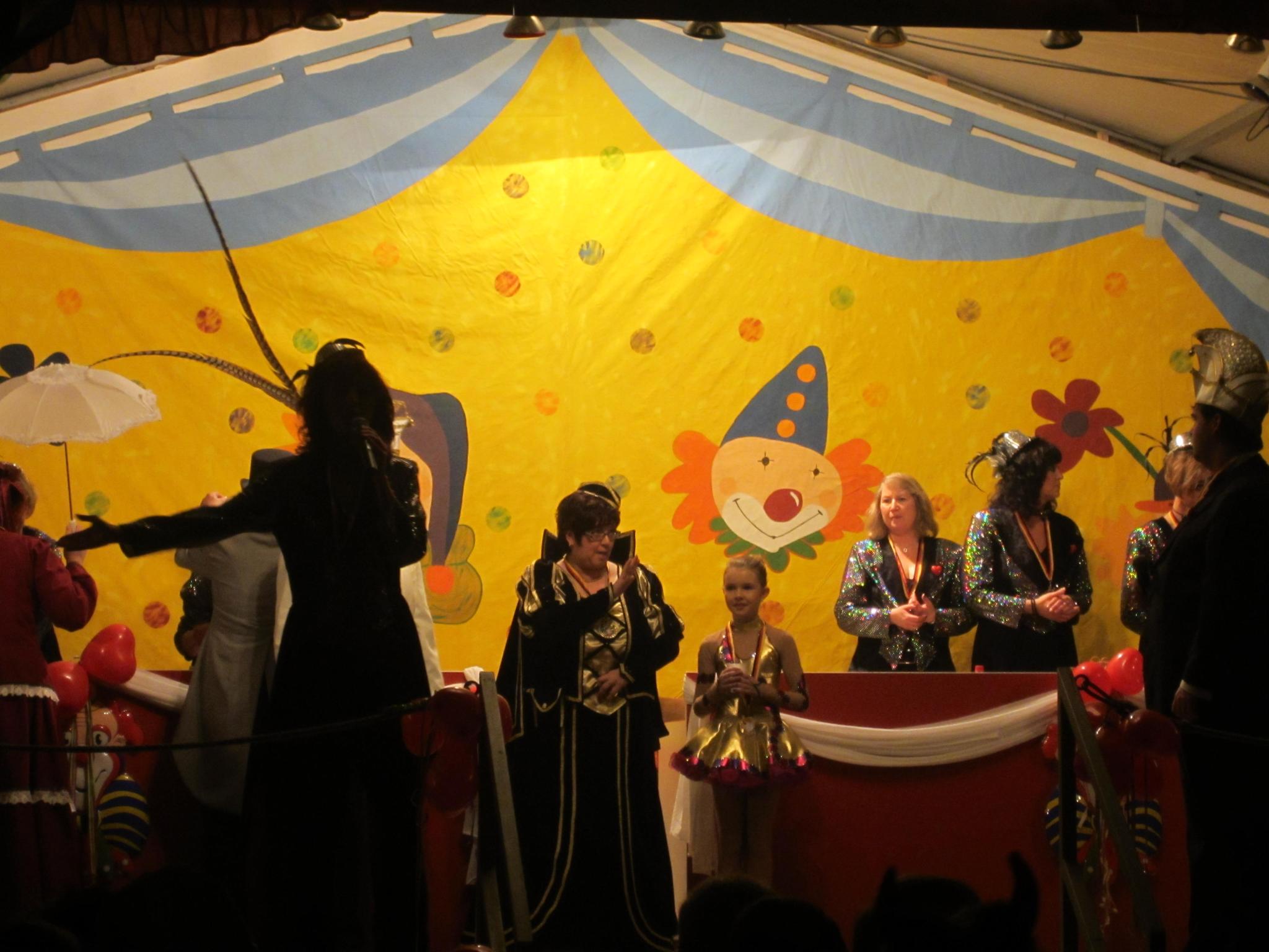 a group of people in costumes standing in front of an elaborate stage