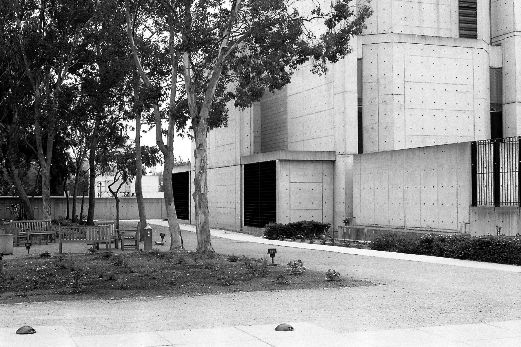 black and white po of a person on skateboard near a large building