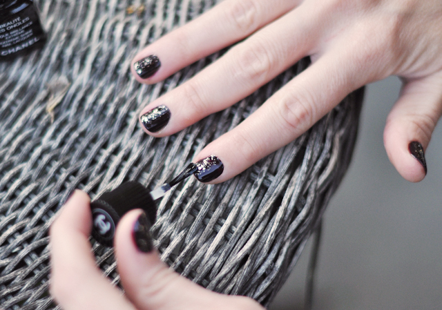 woman's hands with black french manicures and silver nail tips