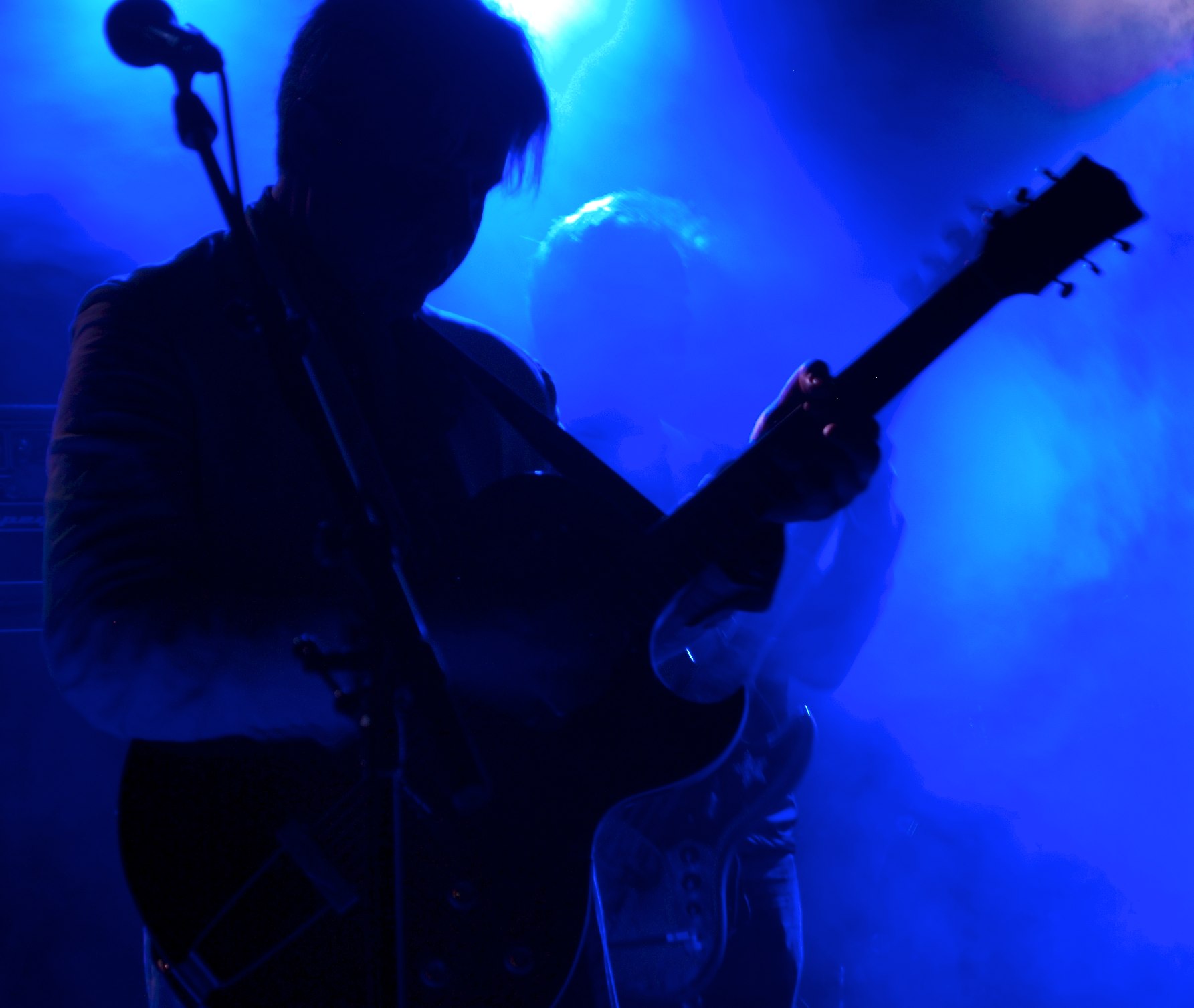 a person on a stage with a guitar