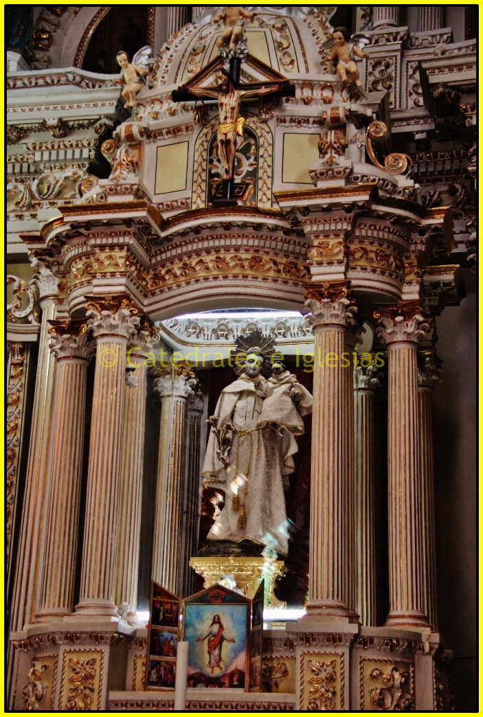 a statue in an ornate alter with columns