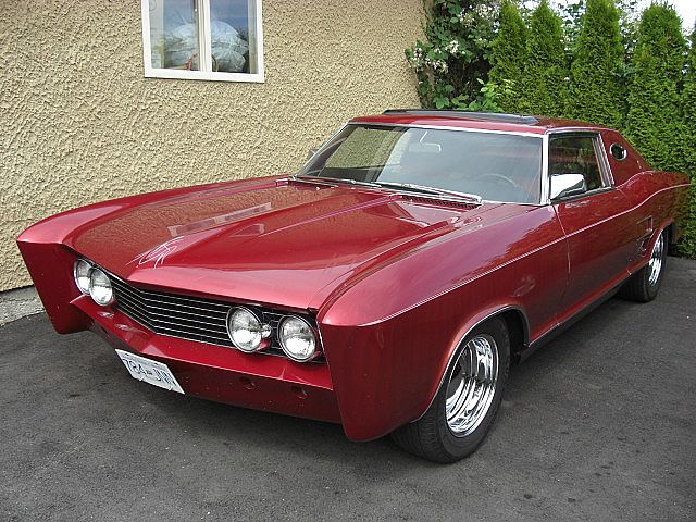 a red car sitting on top of a street