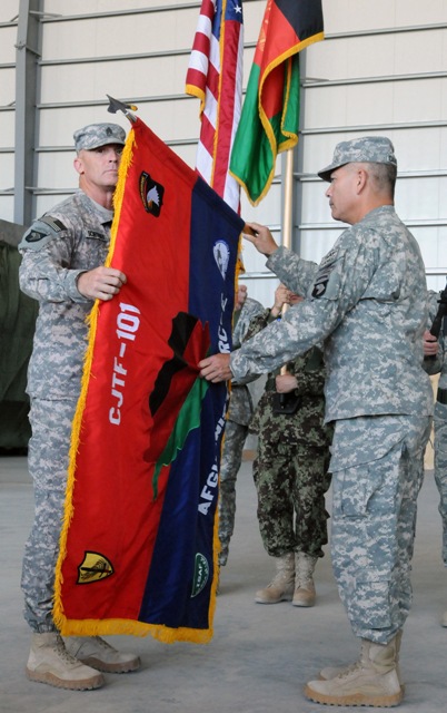 the soldiers are holding a flag with flags behind them