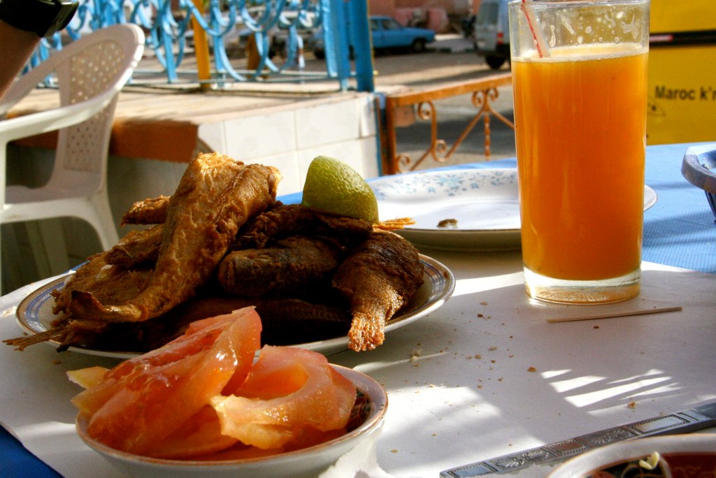 various foods sitting on white dishes at a restaurant table