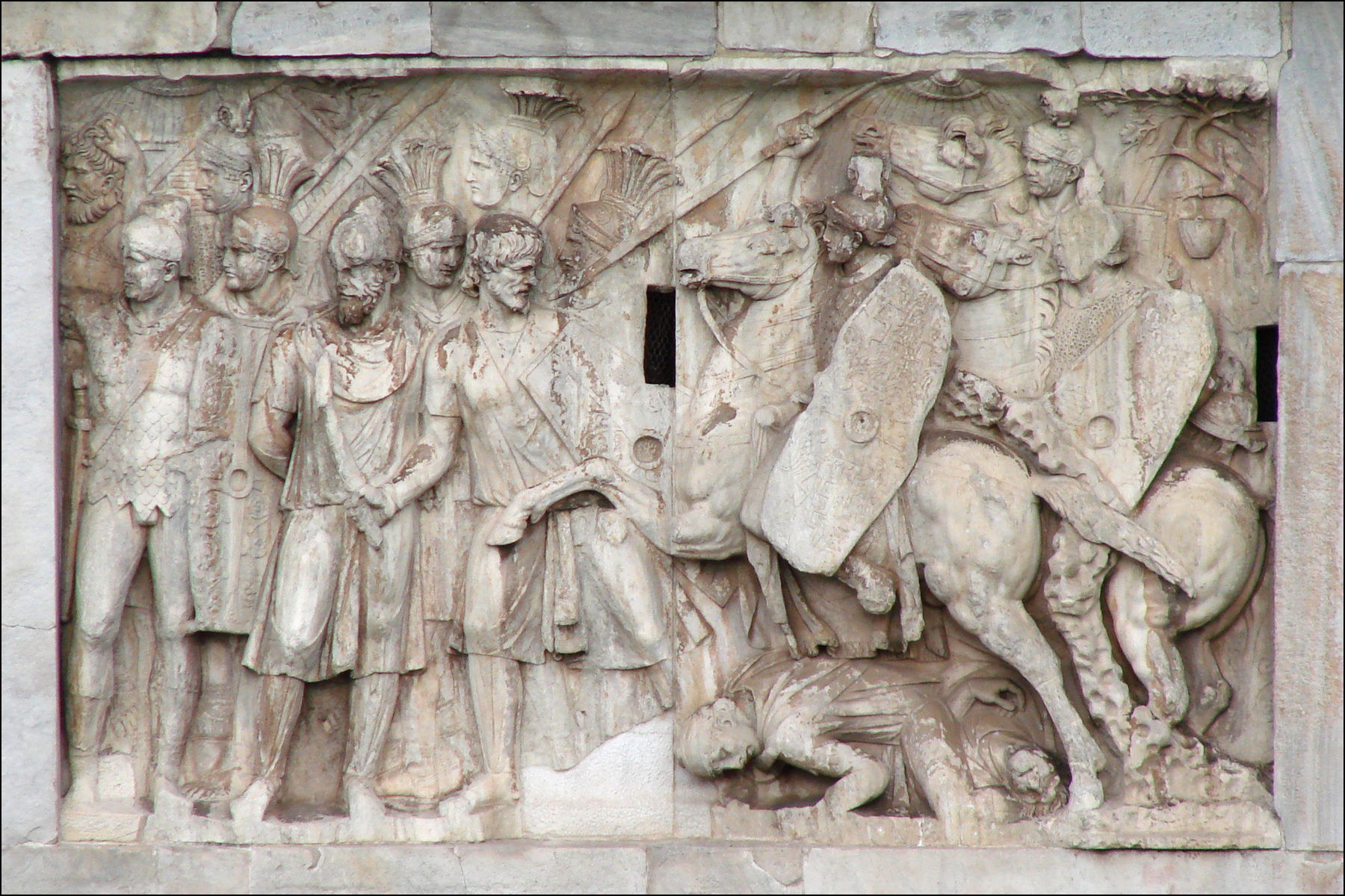 ancient relief carving depicting a war scene and other figures