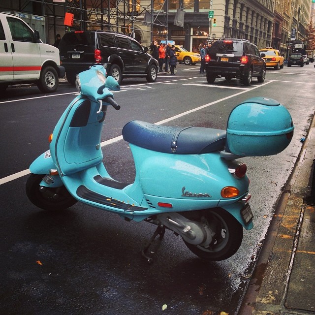 a scooter with blue leather seat and no back