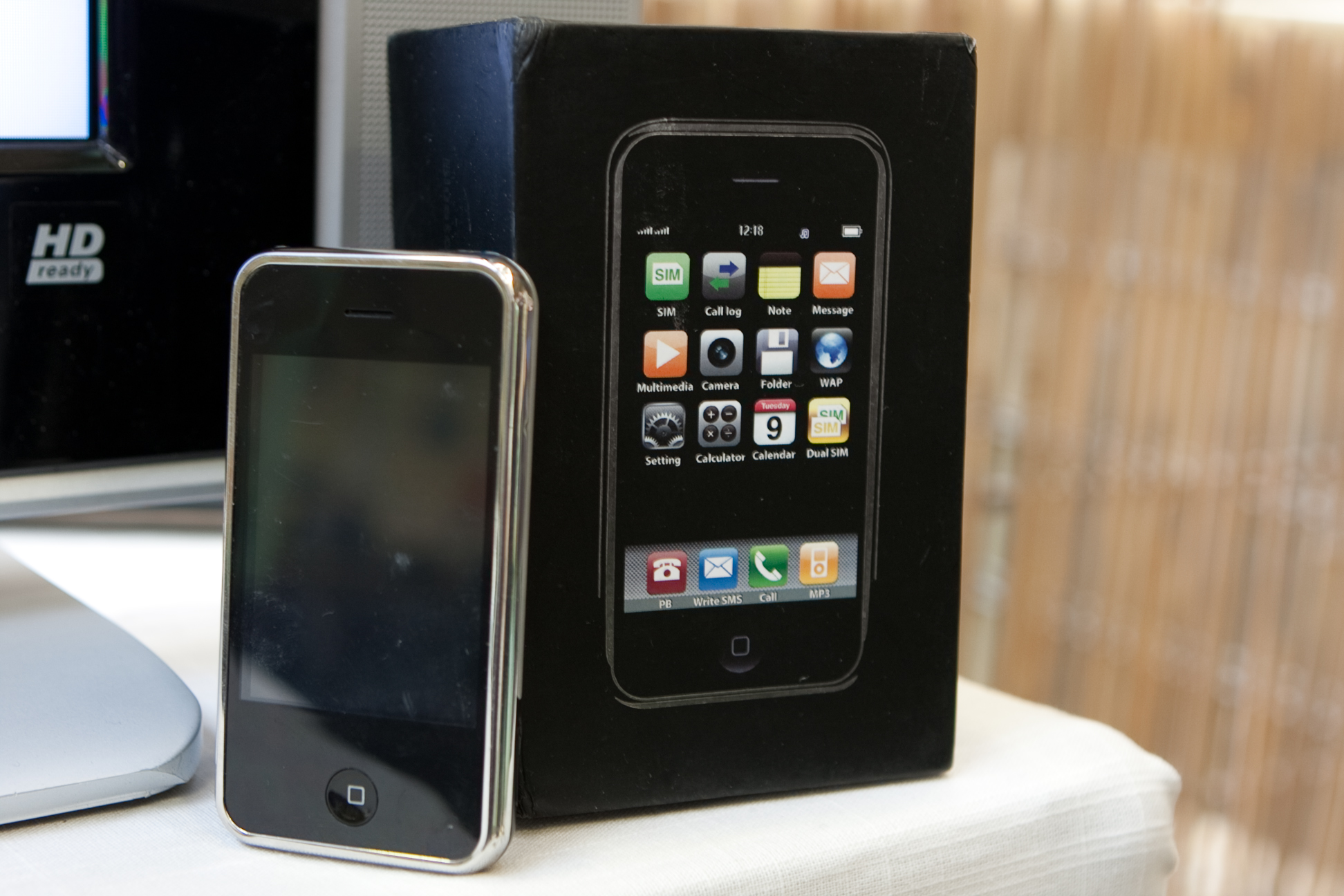 an iphone and a box sitting on a table