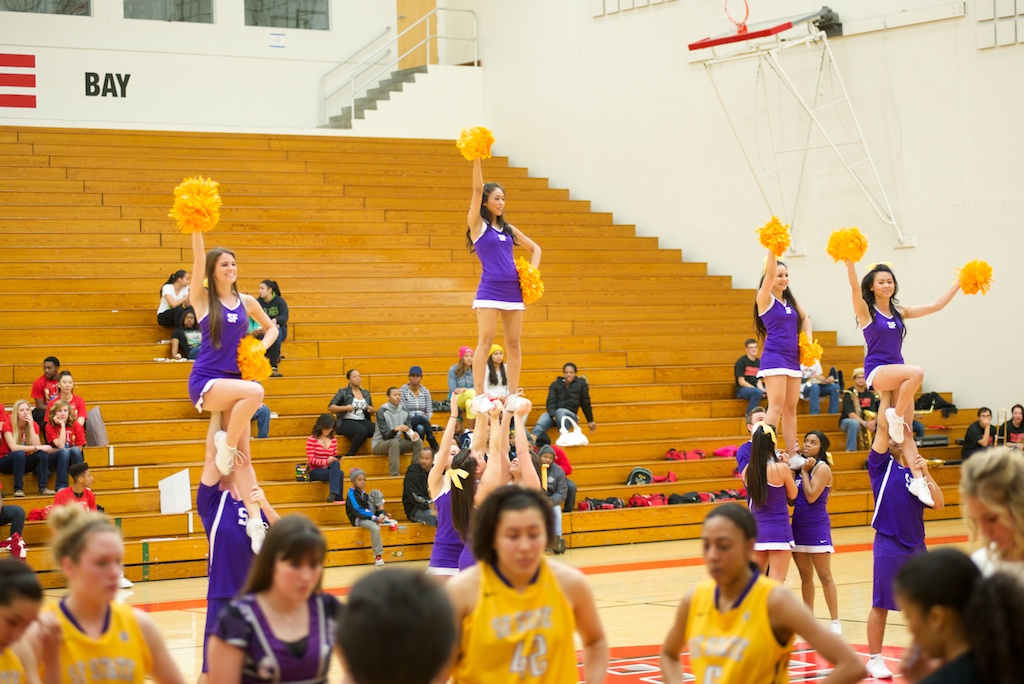 the cheerleaders of the basketball team dance together