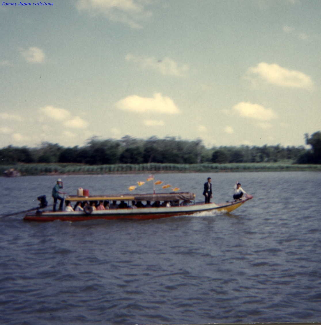 a group of people riding in a boat with large poles