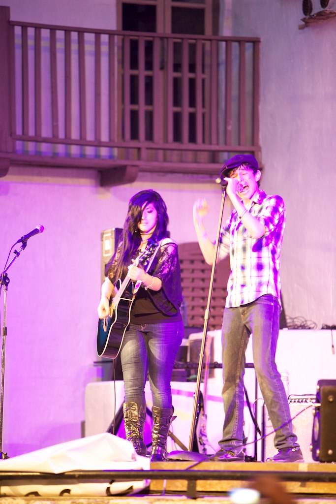 two people are playing instruments on a stage