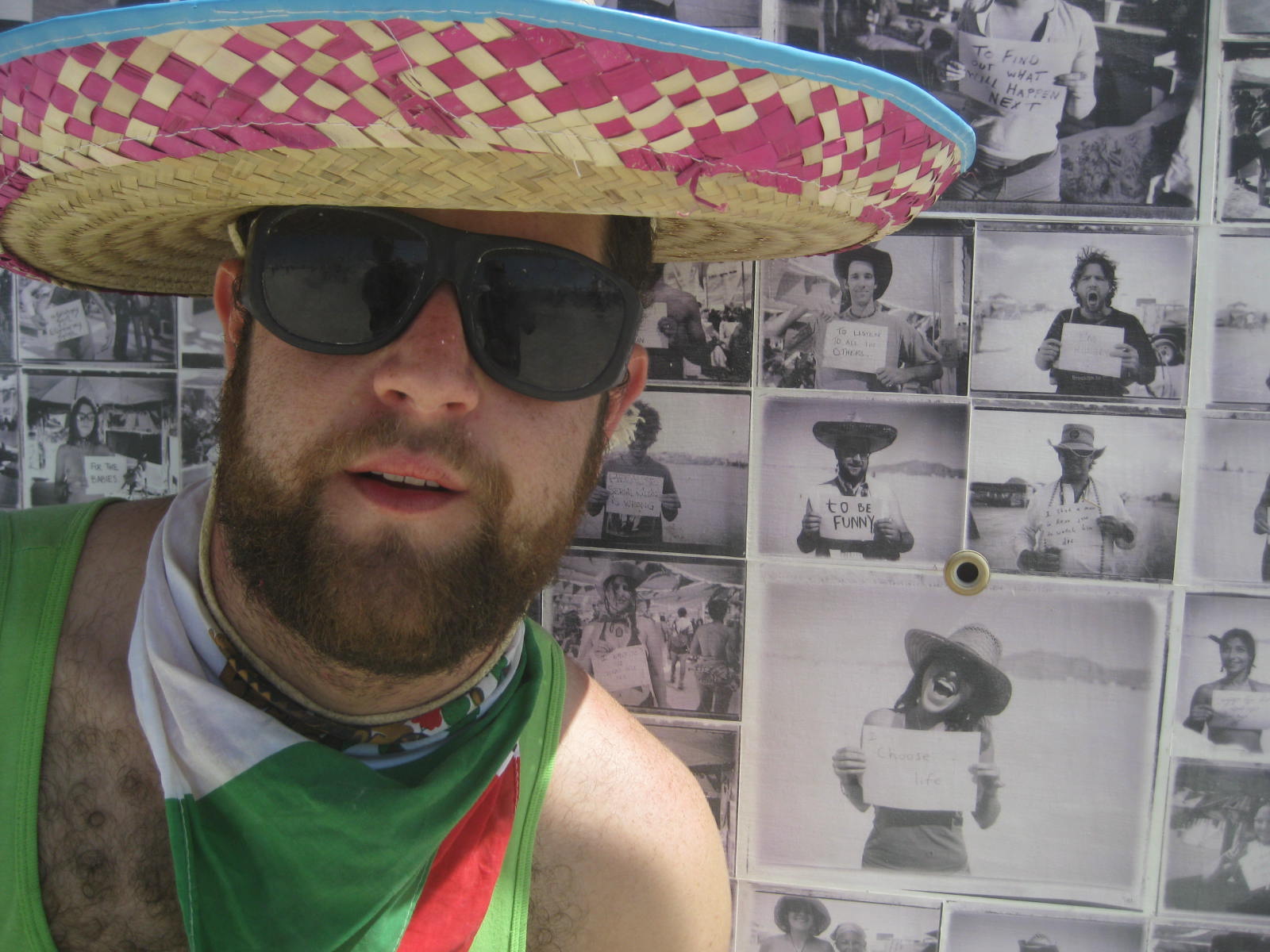 a man with sunglasses on and a sombrero on his head