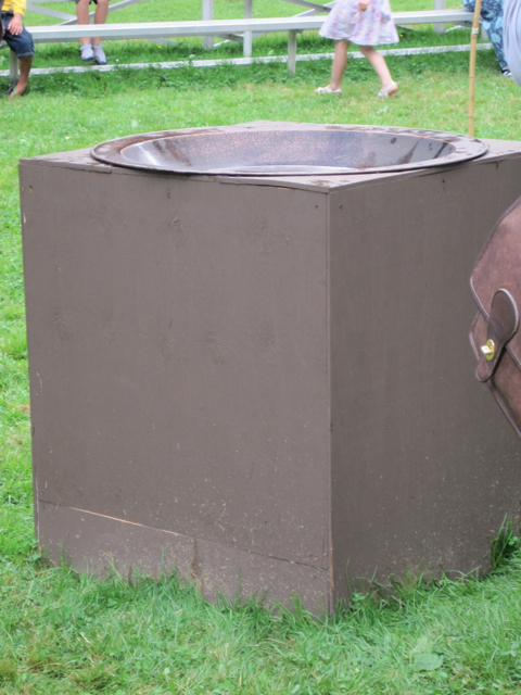 there is a large metal thing sitting in the grass