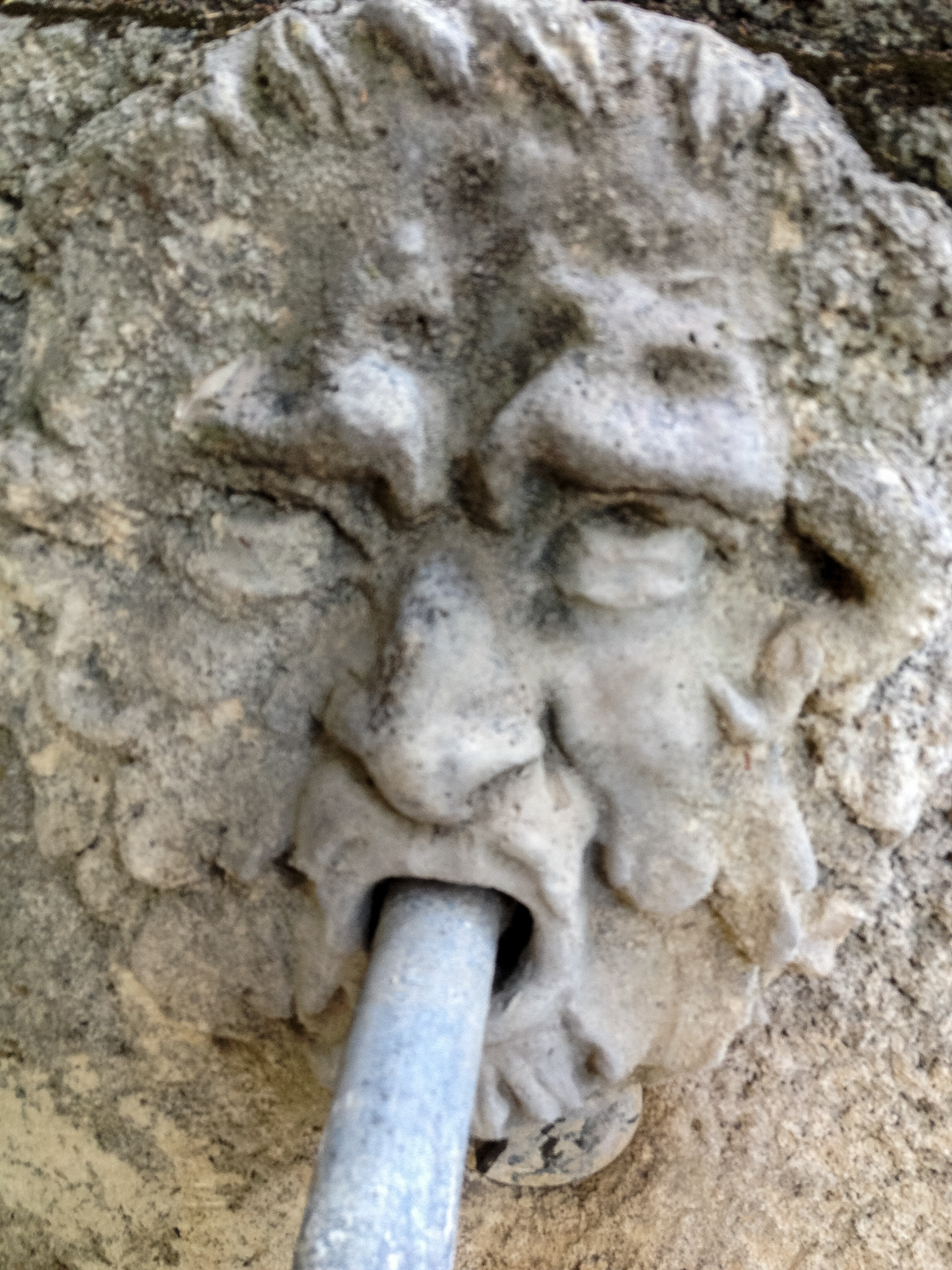a concrete sculpture that looks like a man's head