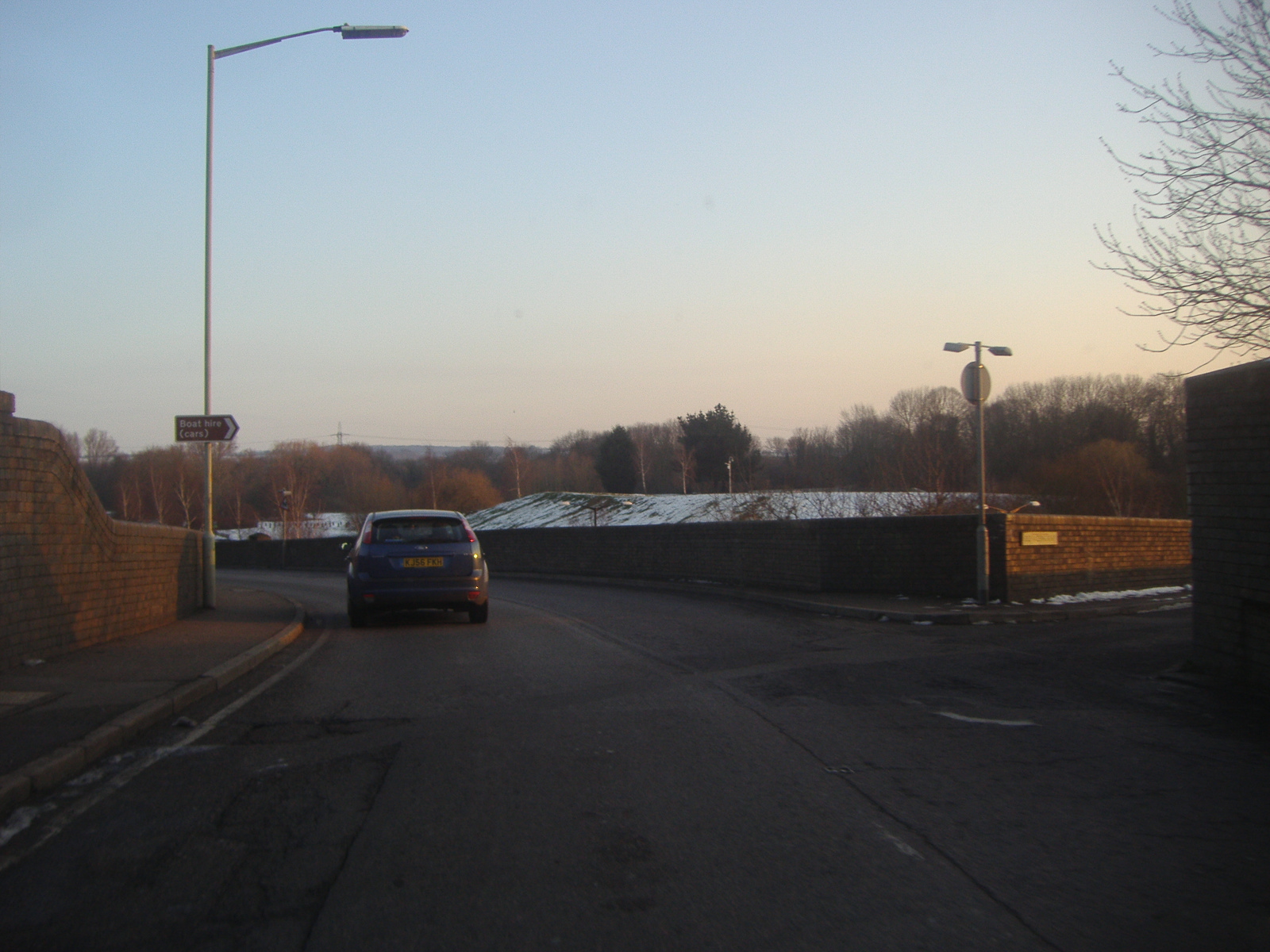 a car driving down a lonely empty road