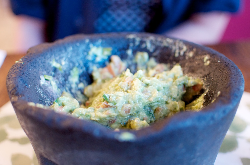 there is a blue ceramic bowl with food inside of it