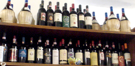 a lot of different types of wines on a shelves