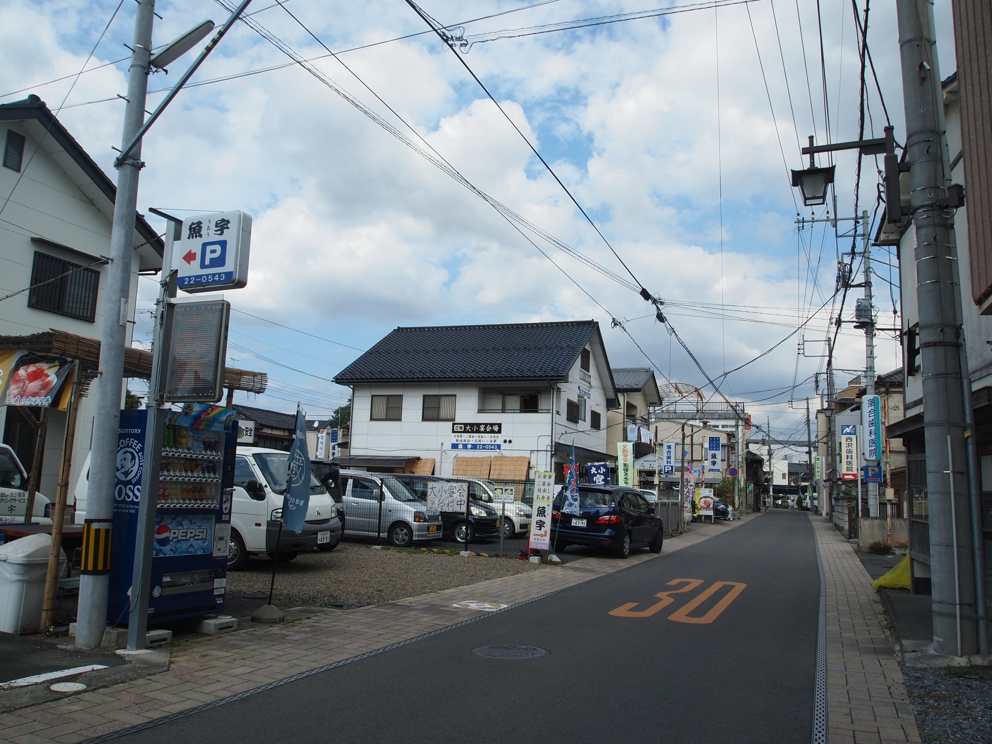 a street filled with cars and a large building