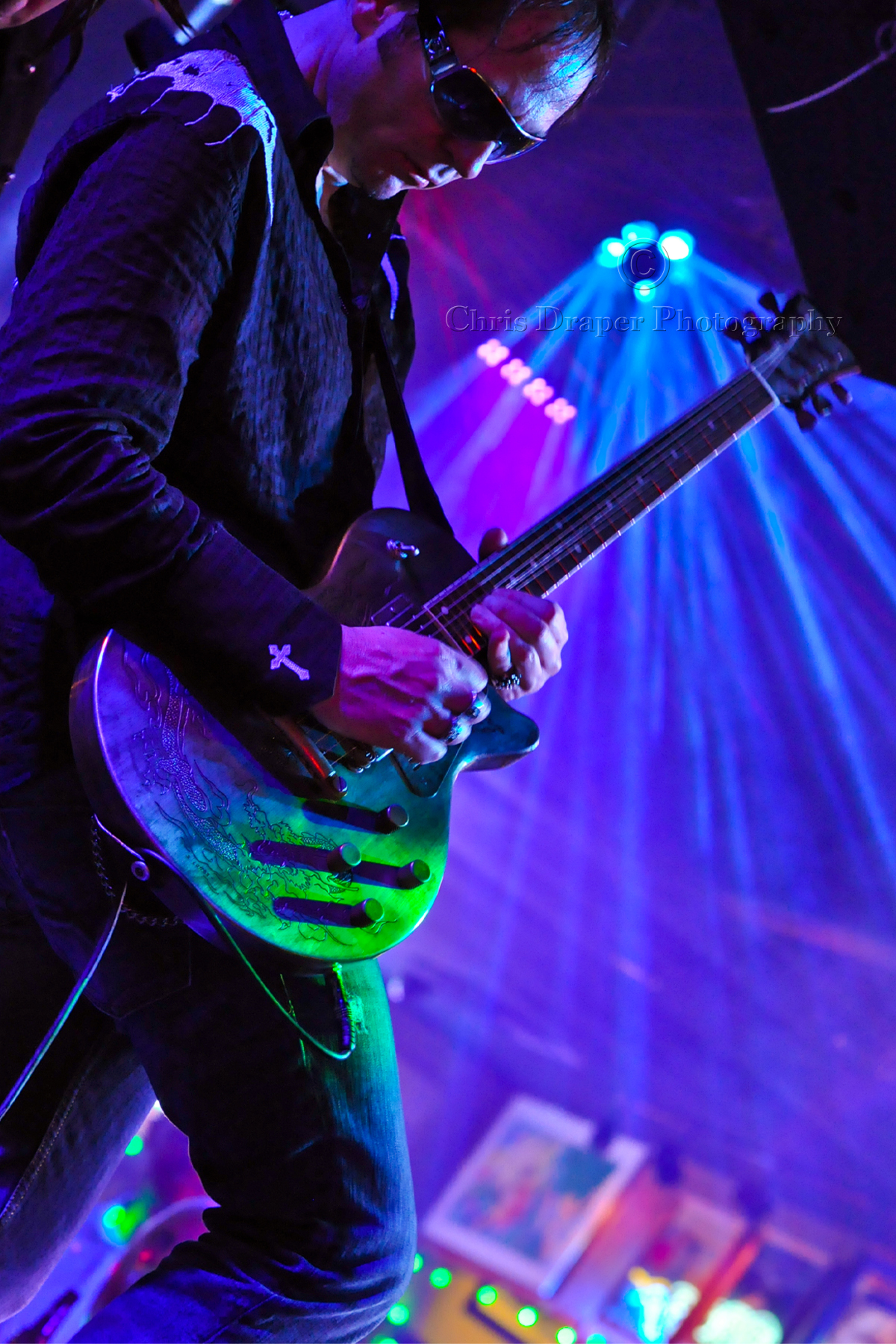 a man with a green guitar and red guitar