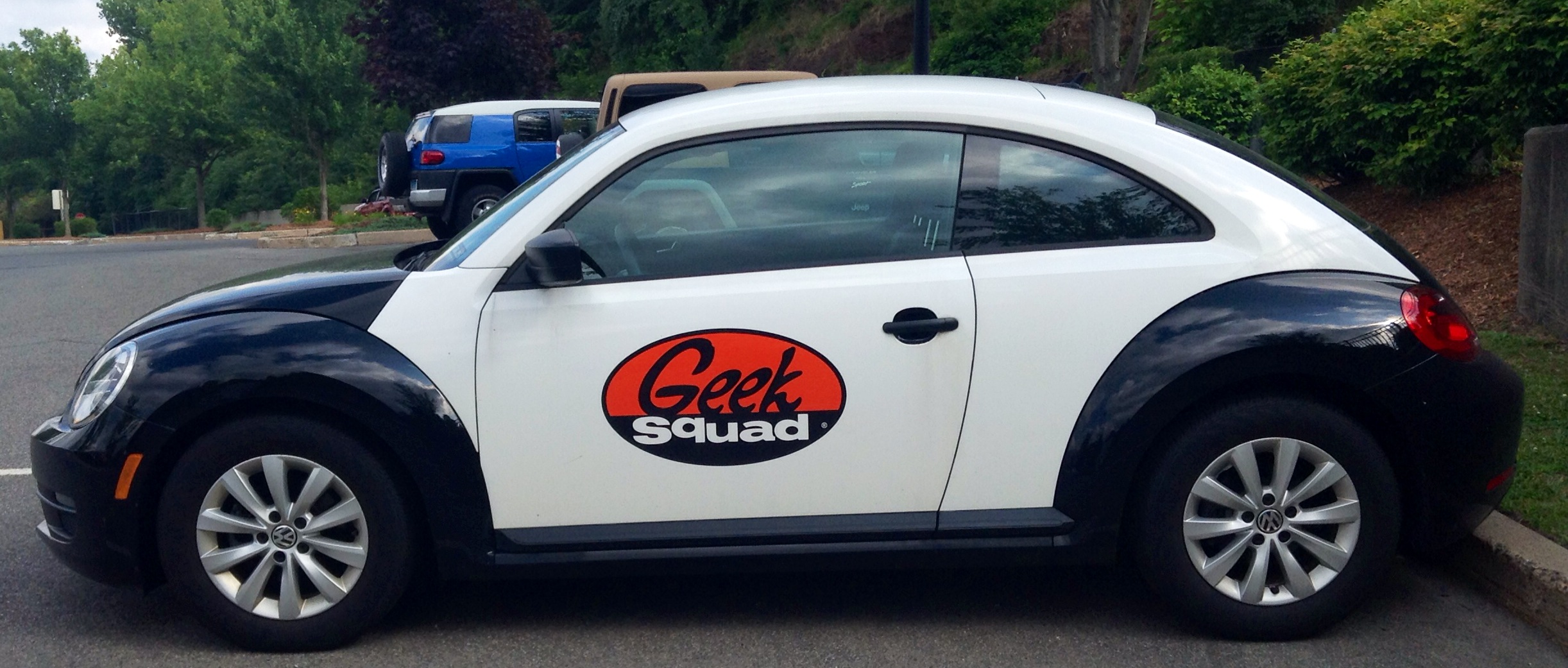 the front view of a white and black car parked on the street