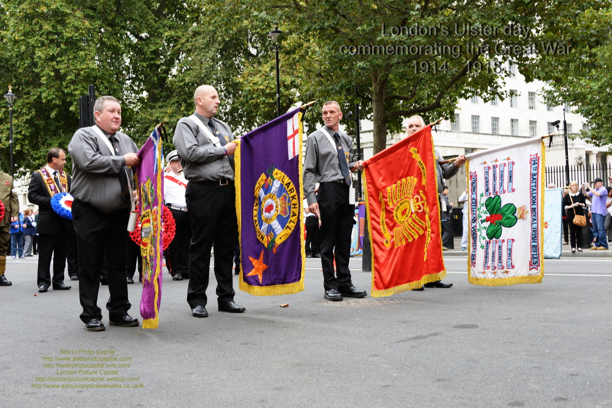men are holding flags and standing in a parade