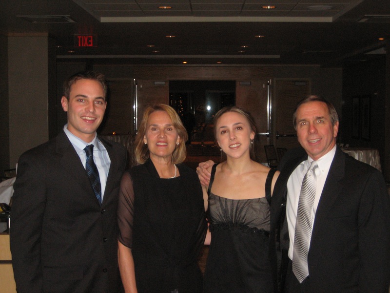 three women and one man standing next to each other