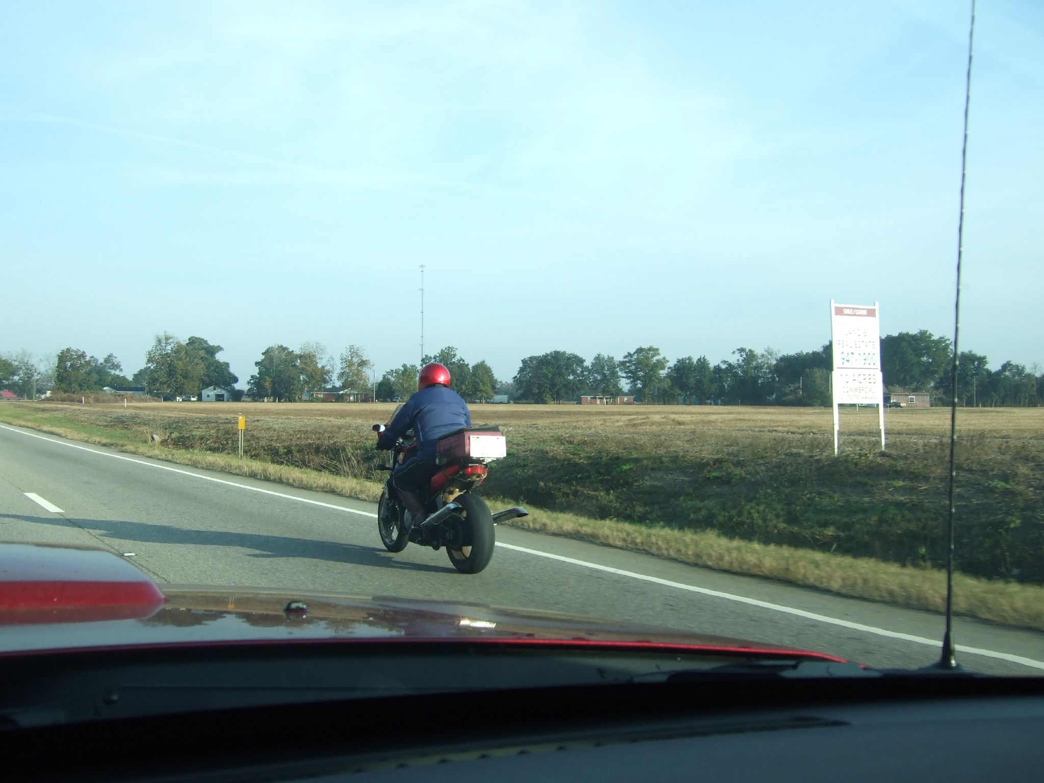 a man on a motorcycle is riding down the highway